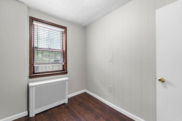 37 Pearsall Ave, Jersey City, NJ 07305 - unfurnished room featuring radiator heating unit, dark wood-type flooring, and baseboards