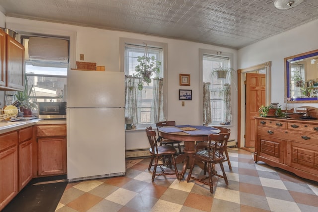 329 Adams St Unit 4, Hoboken, NJ 07030 - dining room with an ornate ceiling, light floors, and a baseboard radiator