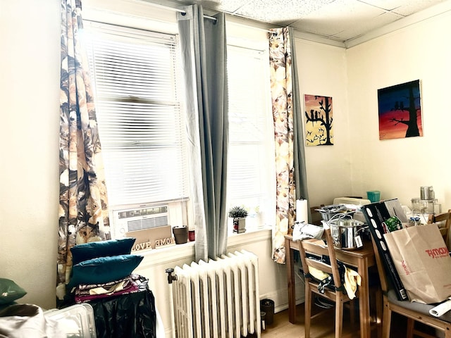 500 New York Ave, Jersey City, NJ 07087 - living area with radiator heating unit, plenty of natural light, a paneled ceiling, and cooling unit