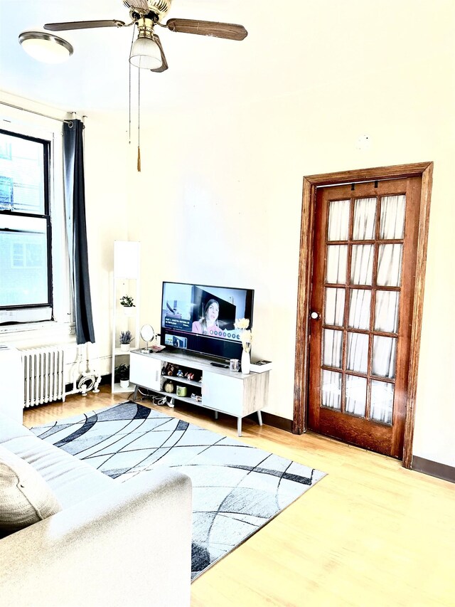 500 New York Ave, Jersey City, NJ 07087 - living area featuring wood finished floors, a ceiling fan, and radiator