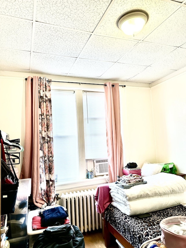 500 New York Ave, Jersey City, NJ 07087 - bedroom featuring radiator heating unit, a drop ceiling, and cooling unit
