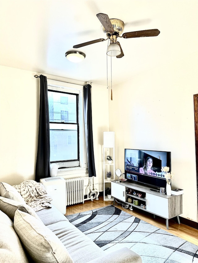 500 New York Ave, Jersey City, NJ 07087 - living area featuring radiator heating unit, wood finished floors, and ceiling fan