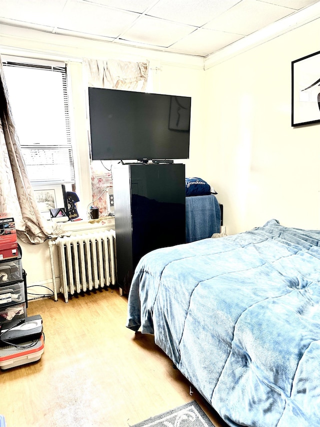 500 New York Ave, Jersey City, NJ 07087 - bedroom featuring radiator, a drop ceiling, and wood finished floors