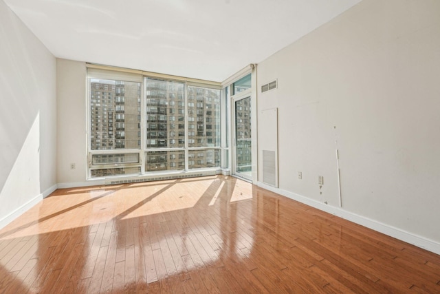 20 Newport Pkwy Unit 1006, Jersey City, NJ 07310 - spare room featuring healthy amount of natural light, hardwood / wood-style floors, floor to ceiling windows, and baseboards