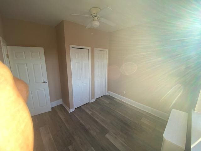 680 Kennedy Blvd Unit 406, Bayonne, NJ 07002 - unfurnished bedroom featuring wood finished floors, baseboards, two closets, and a ceiling fan