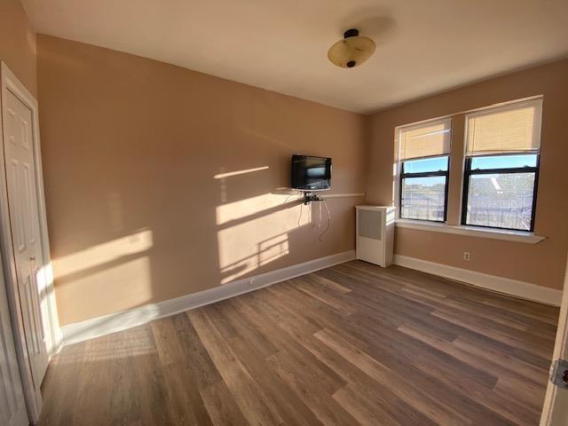 680 Kennedy Blvd Unit 406, Bayonne, NJ 07002 - unfurnished room featuring baseboards and dark wood-style floors