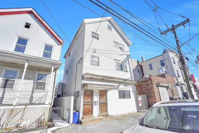 view of front facade featuring a porch and fence