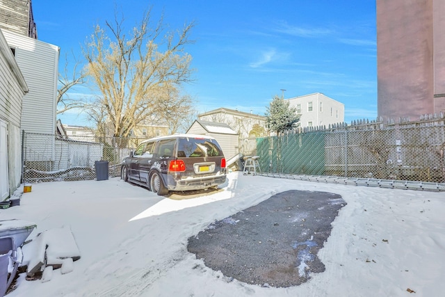 yard layered in snow featuring a fenced backyard