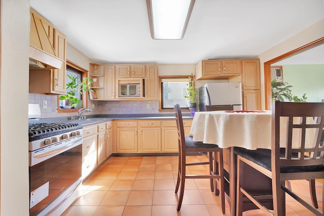 kitchen with open shelves, light tile patterned flooring, light brown cabinetry, appliances with stainless steel finishes, and tasteful backsplash