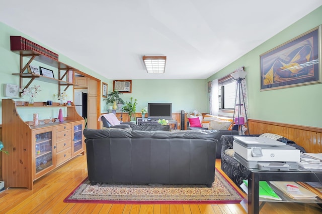 living area with a wainscoted wall and hardwood / wood-style floors