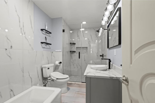 498 Teal Plz, Secaucus, NJ 07094 - full bath with toilet, a marble finish shower, vanity, marble look tiles, and a tub to relax in
