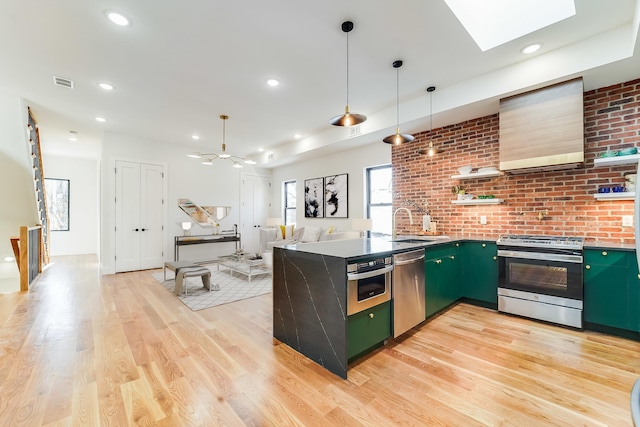 72 Lincoln St Unit 2, Jersey City, NJ 07307 - kitchen with appliances with stainless steel finishes, green cabinetry, a peninsula, light wood-style floors, and a sink