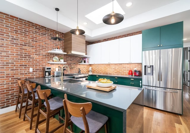 72 Lincoln St Unit 2, Jersey City, NJ 07307 - kitchen featuring stainless steel fridge, open shelves, dark countertops, a sink, and a peninsula