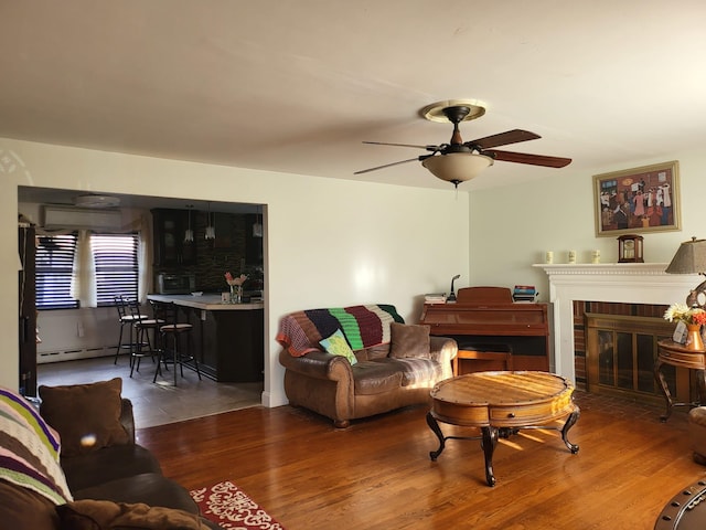 403 Hamilton St, Roselle Boro, NJ 07203 - living room featuring a baseboard radiator, a brick fireplace, ceiling fan, and wood finished floors