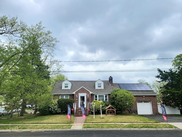 403 Hamilton St, Roselle Boro, NJ 07203 - cape cod-style house with brick siding, aphalt driveway, solar panels, and a garage