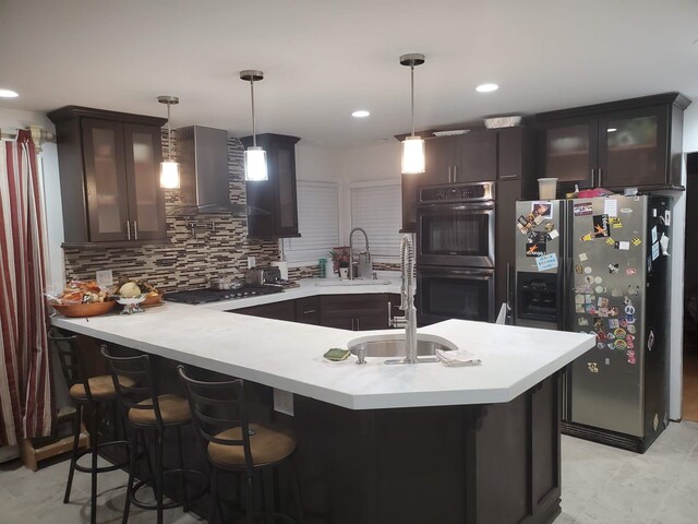 403 Hamilton St, Roselle Boro, NJ 07203 - kitchen featuring wall chimney range hood, a sink, stainless steel fridge with ice dispenser, light countertops, and double oven