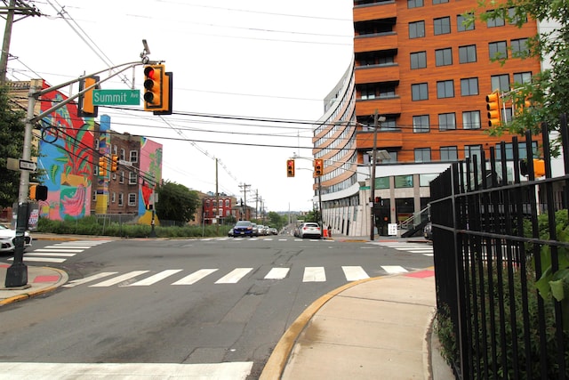 154 Fairmount Ave, Jersey City, NJ 07304 - view of asphalt street featuring traffic lights, sidewalks, curbs, and street lights