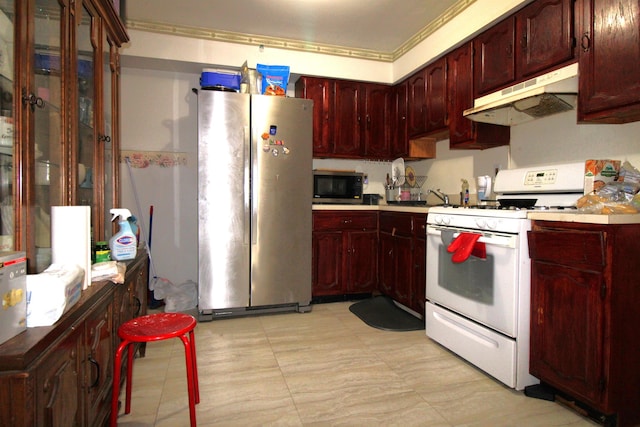 154 Fairmount Ave, Jersey City, NJ 07304 - kitchen with appliances with stainless steel finishes, under cabinet range hood, reddish brown cabinets, and light countertops