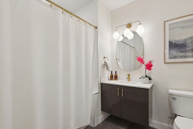 full bath with tile patterned floors, baseboards, toilet, and vanity