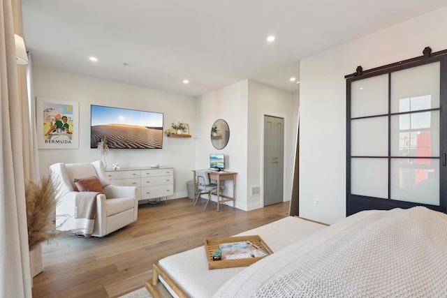 bedroom featuring recessed lighting, visible vents, baseboards, and wood finished floors