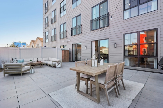 view of patio with outdoor lounge area, outdoor dining area, and fence