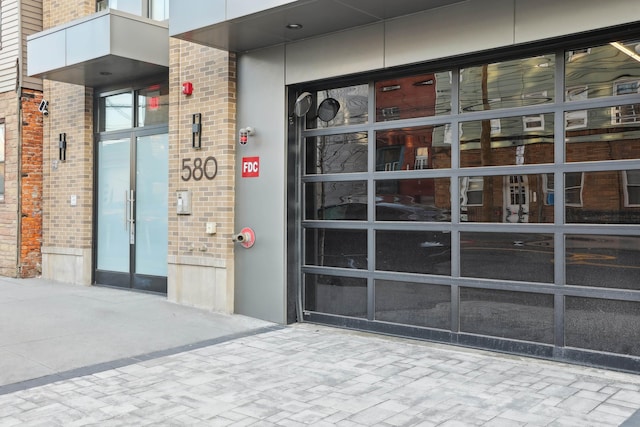 view of exterior entry with brick siding