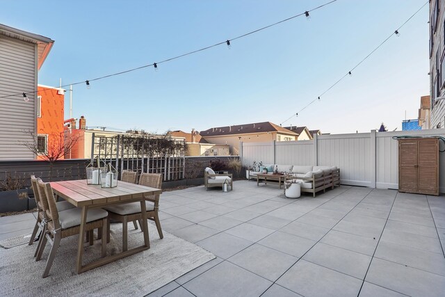 view of patio / terrace featuring outdoor dining space, an outdoor hangout area, and fence