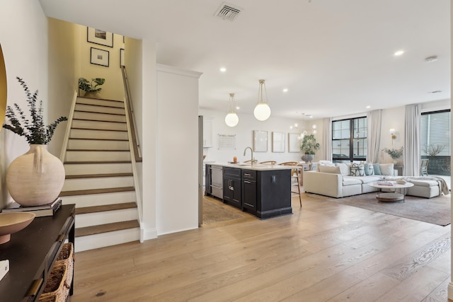 interior space with recessed lighting, visible vents, light wood-style flooring, and stairway