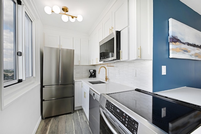 kitchen with sink, white cabinets, decorative backsplash, stainless steel appliances, and dark wood-type flooring