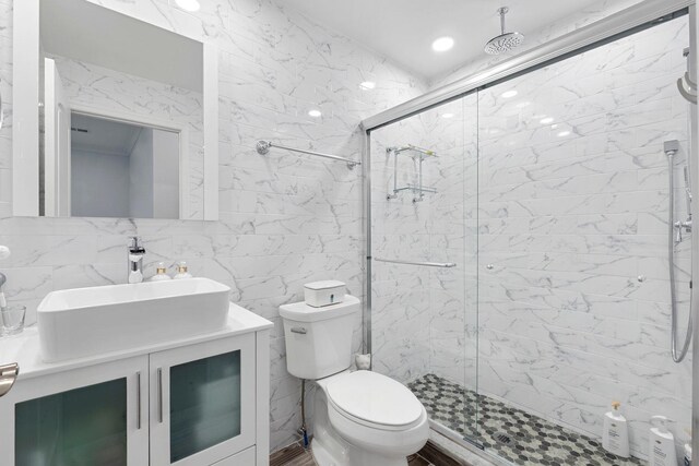 42 Grace St Unit 2, Jersey City, NJ 07307 - full bathroom with a marble finish shower, tile walls, vanity, and backsplash