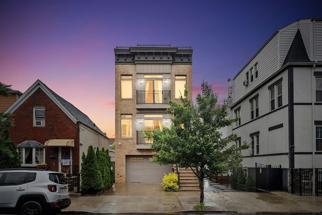42 Grace St Unit 2, Jersey City, NJ 07307 - view of front of home with brick siding, a garage, concrete driveway, and a balcony
