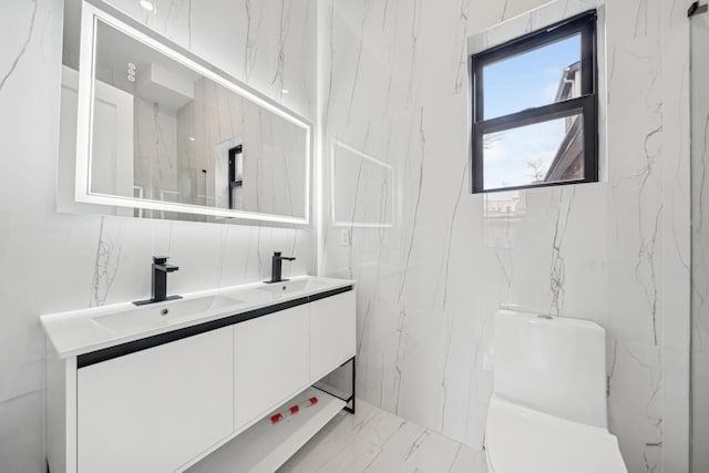 bathroom featuring vanity, tile walls, and toilet