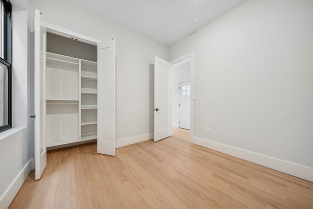 unfurnished bedroom with light wood-type flooring