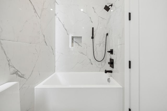 bathroom featuring tiled shower / bath and toilet