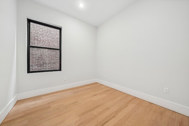 unfurnished room with hardwood / wood-style flooring