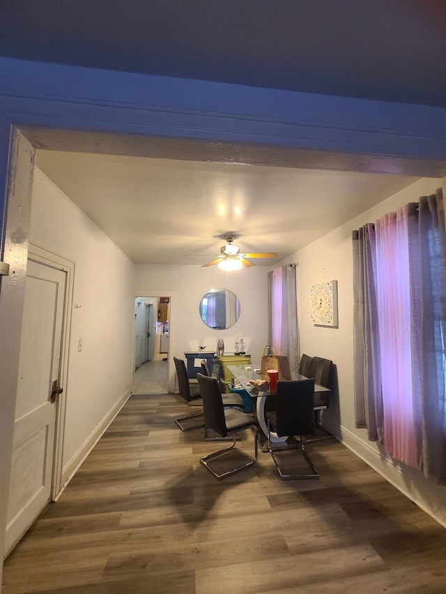 dining room with wood finished floors, baseboards, and ceiling fan