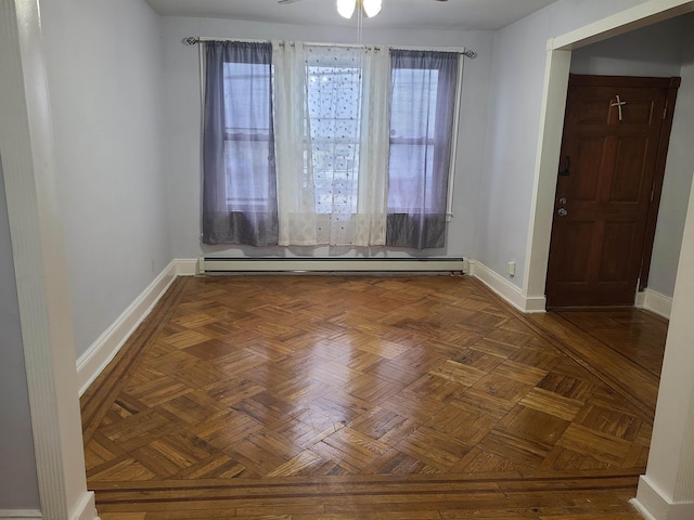 unfurnished room featuring ceiling fan, a baseboard heating unit, and baseboards