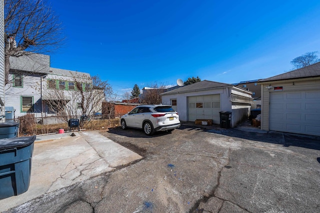 exterior space featuring a garage and fence