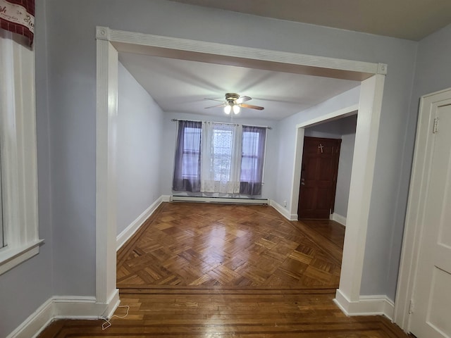 interior space with a baseboard radiator, baseboards, and ceiling fan