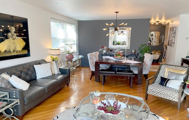 living room with light hardwood / wood-style flooring and a chandelier