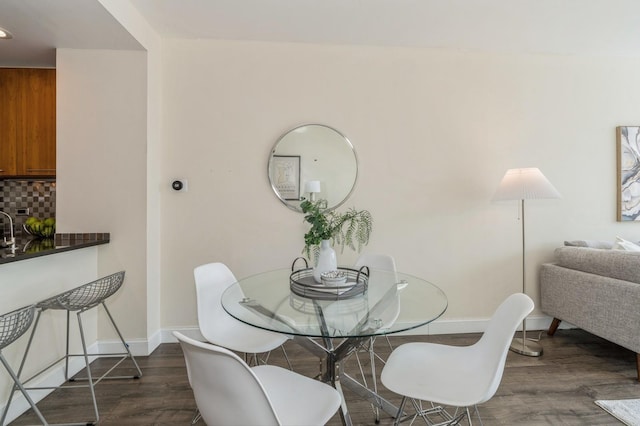 dining area with dark wood-type flooring