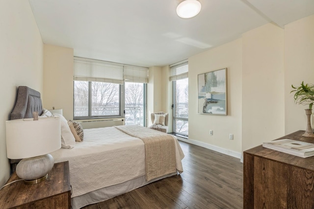 bedroom featuring access to exterior and dark hardwood / wood-style floors