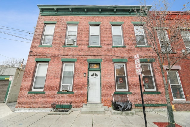 view of front of home featuring cooling unit and brick siding