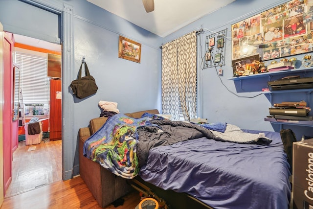 bedroom with wood finished floors and a ceiling fan