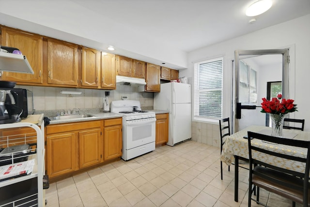 215 48th St Unit 101, Union City, NJ 07087 - kitchen featuring white appliances, a sink, under cabinet range hood, light countertops, and light tile patterned floors