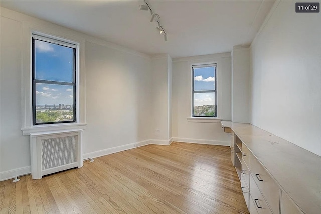 2600 Kennedy Blvd Unit 7A, Jersey City, NJ 07306 - spare room featuring track lighting, light wood-type flooring, radiator, and crown molding