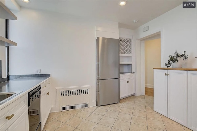 2600 Kennedy Blvd Unit 7A, Jersey City, NJ 07306 - kitchen with freestanding refrigerator, dishwasher, white cabinets, radiator heating unit, and light tile patterned floors