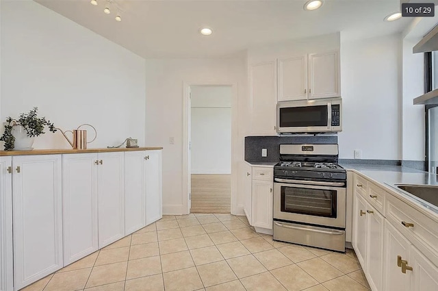 2600 Kennedy Blvd Unit 7A, Jersey City, NJ 07306 - kitchen featuring appliances with stainless steel finishes, white cabinetry, light tile patterned flooring, and recessed lighting