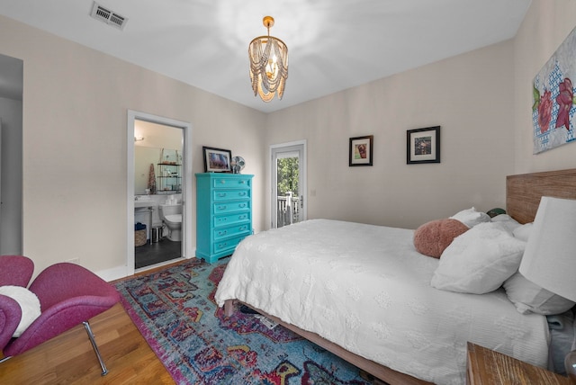 390 1st St Unit 3, Jersey City, NJ 07302 - bedroom featuring wood finished floors, access to outside, a chandelier, and connected bathroom