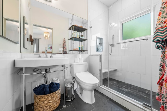 390 1st St Unit 3, Jersey City, NJ 07302 - full bath with tile walls, a shower stall, tile patterned flooring, a chandelier, and a wainscoted wall